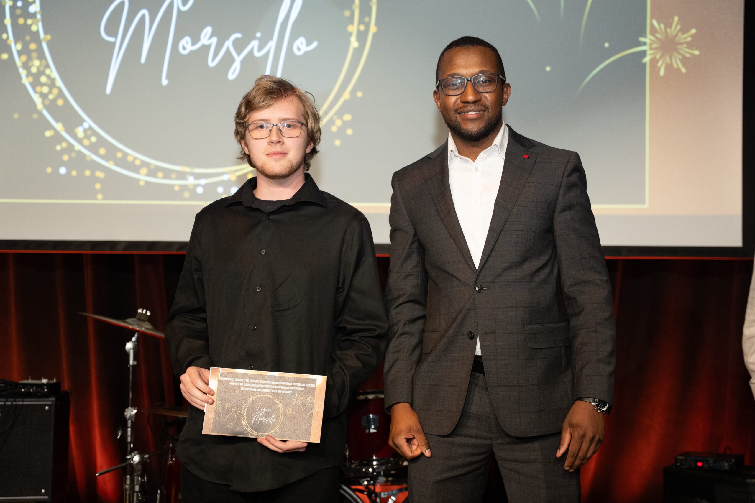 Logan Morsillo receiving his award from the National Bank representative, Mr Gourouza.