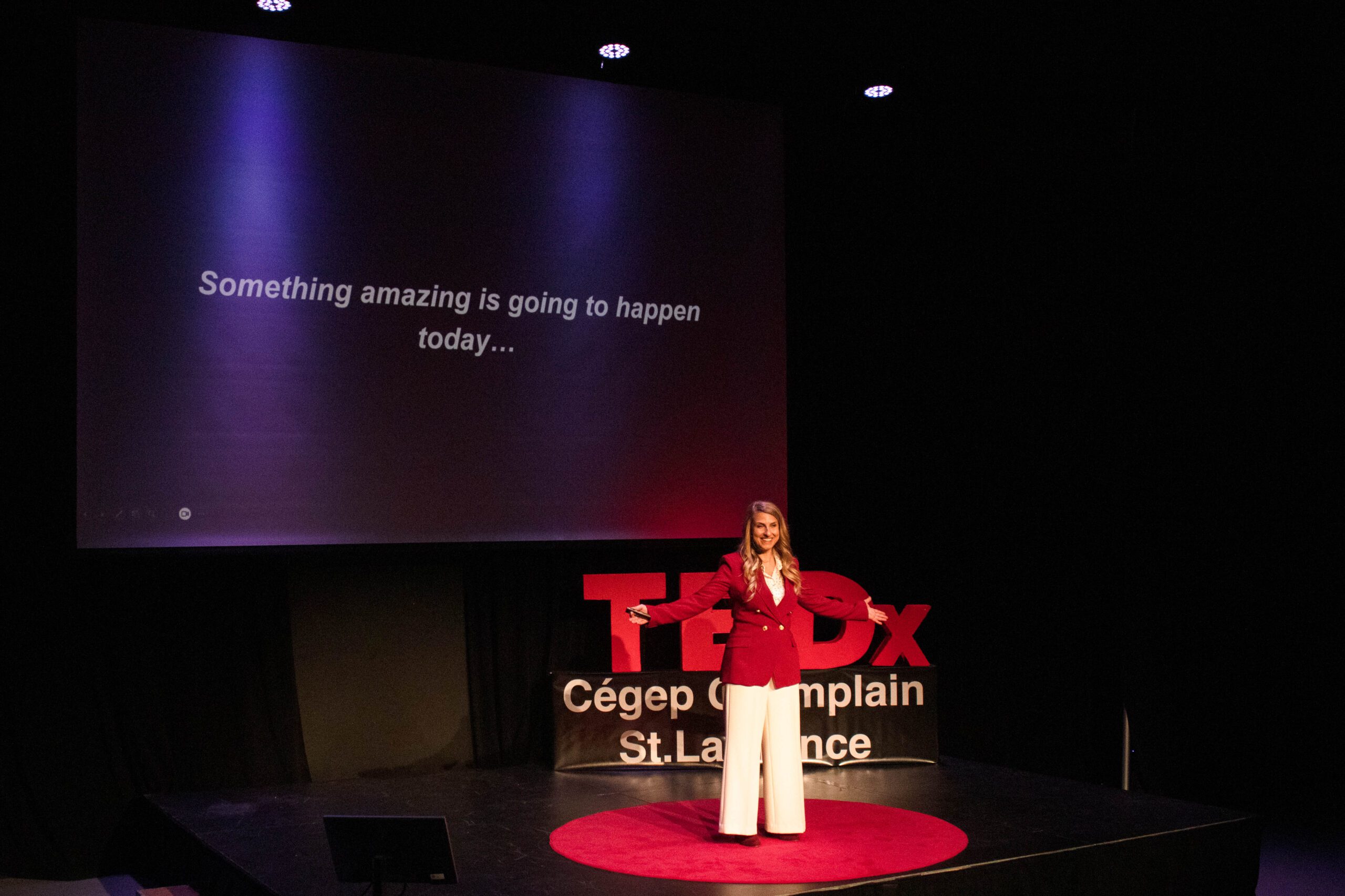 Guest speaker gives a talk in front of the TEDx sign