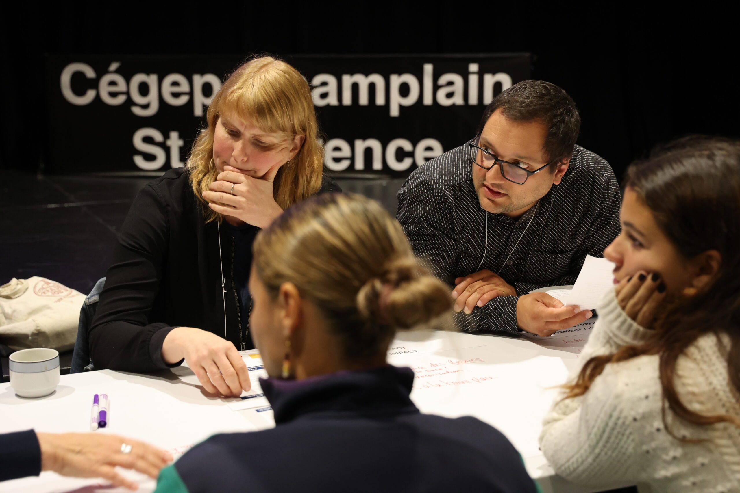 Employees sit around a table at a workshop